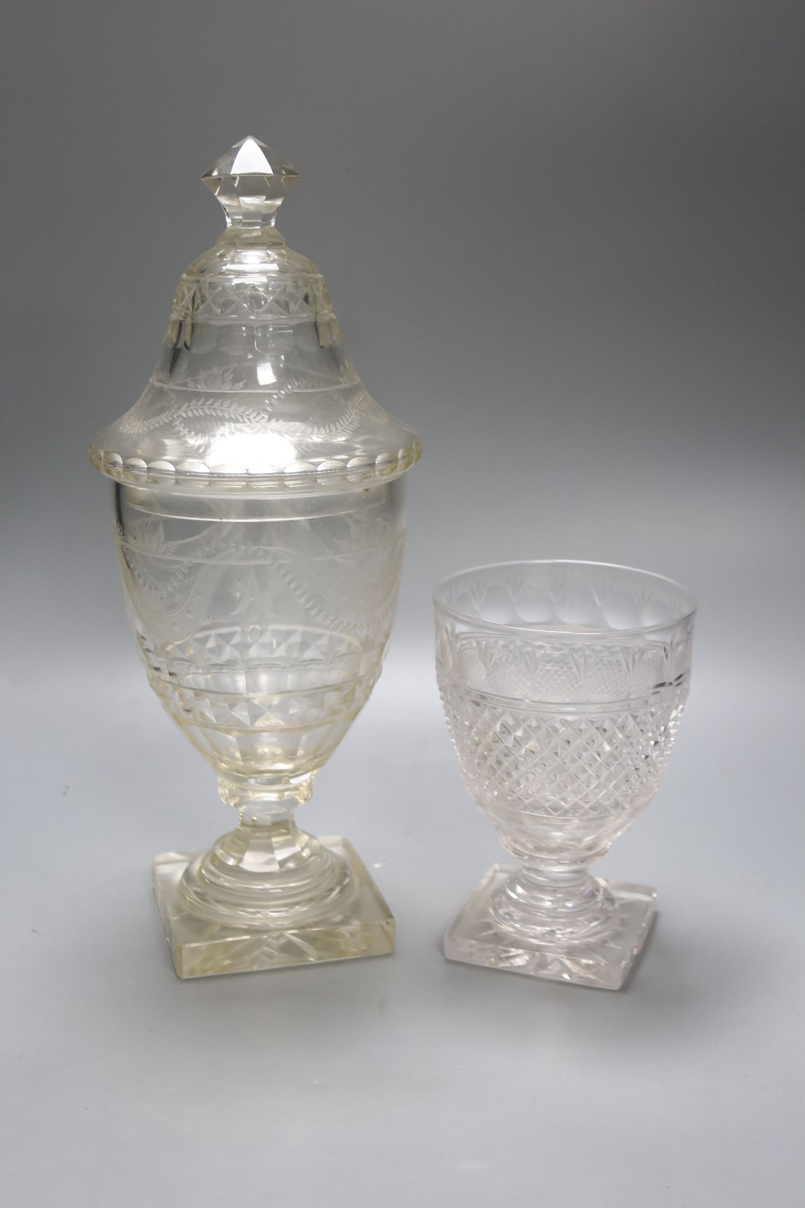 A Regency cut glass urn and cover and another urn